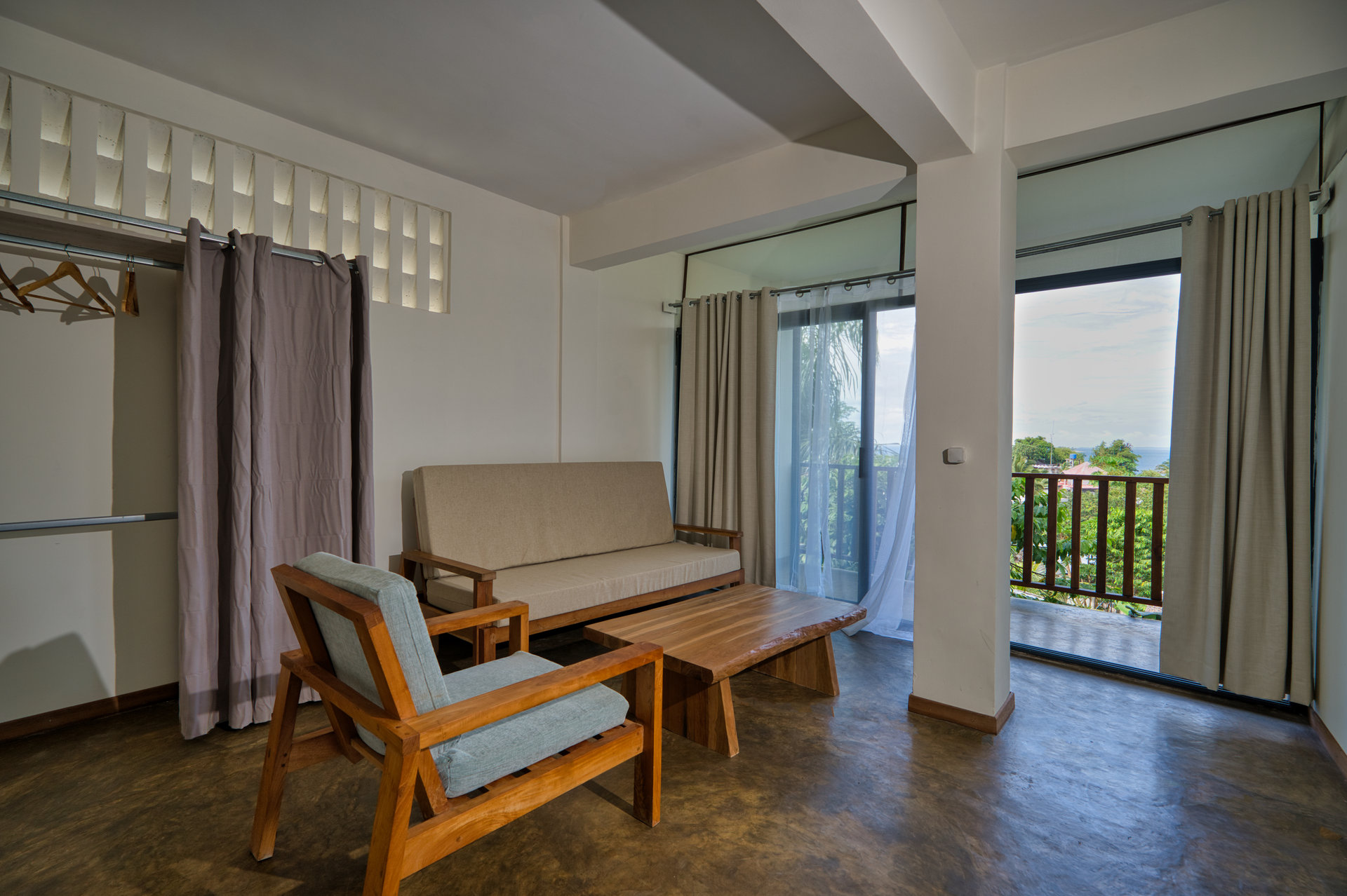 Family Studio — bright lounge area opening onto ocean-view balcony