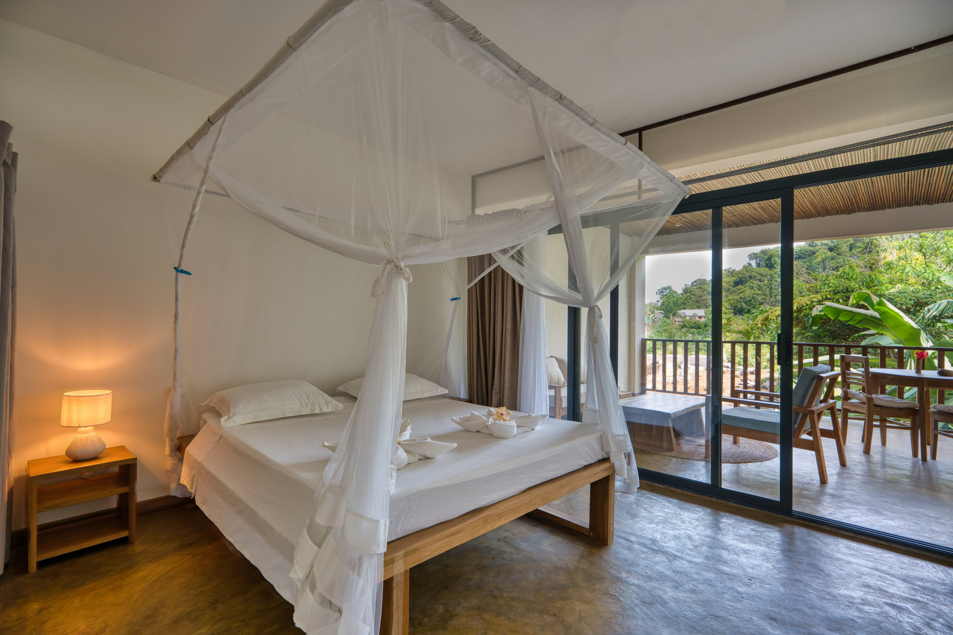 Studio with Ocean View canopy bed and private balcony with jungle view