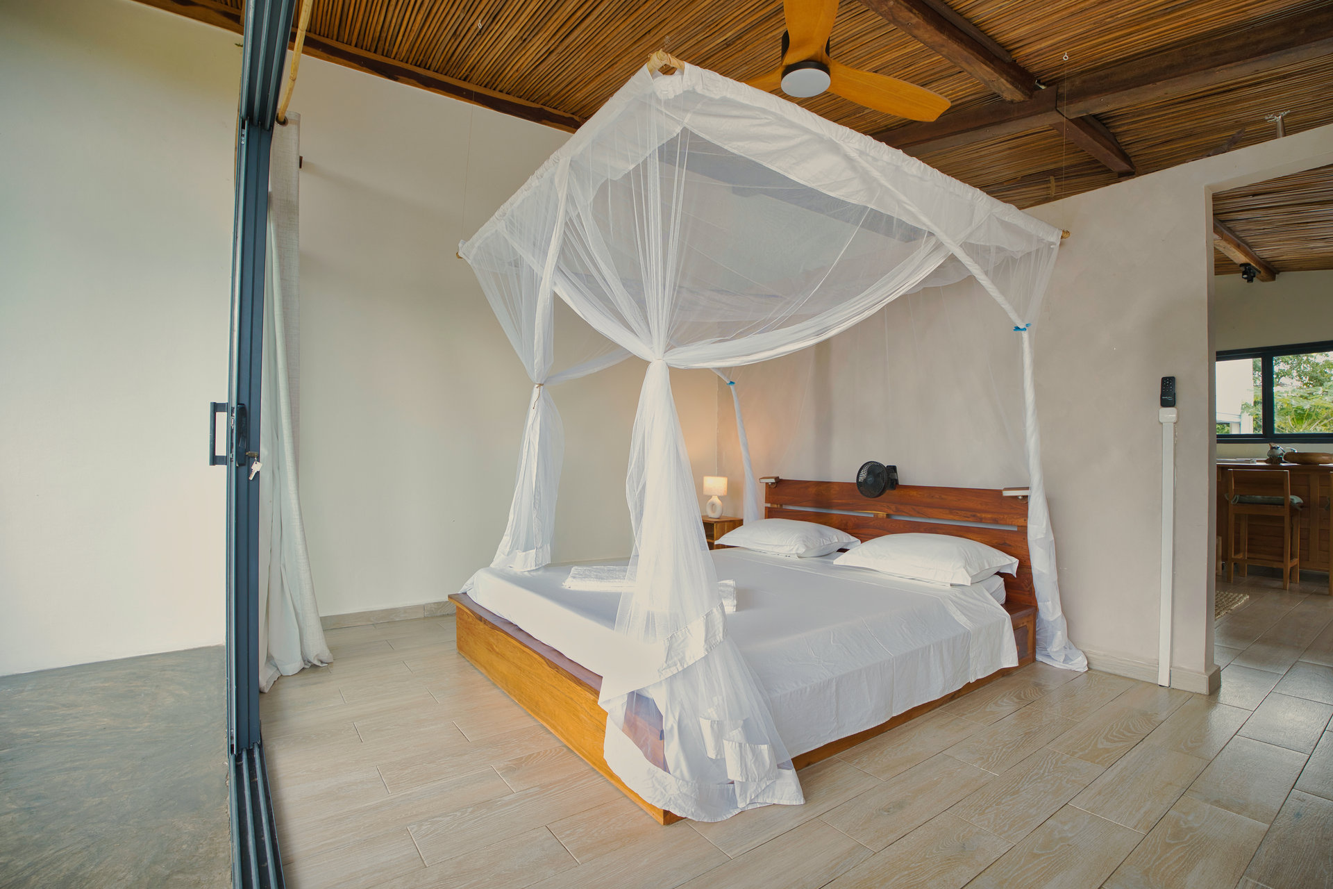 Superior Family Suite bedroom with canopy bed, ceiling fan and kitchenette area